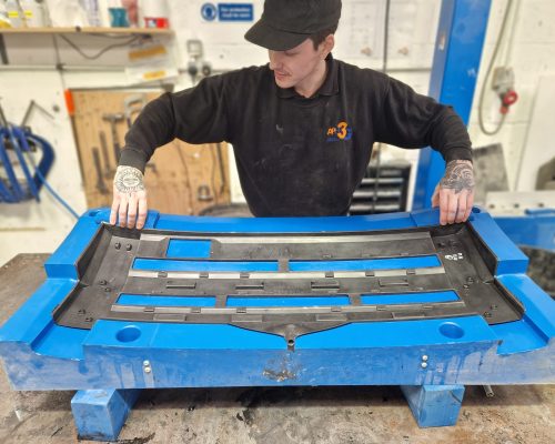 Removal Of An Automotive Trim Panel From The RIM Moulding Tool